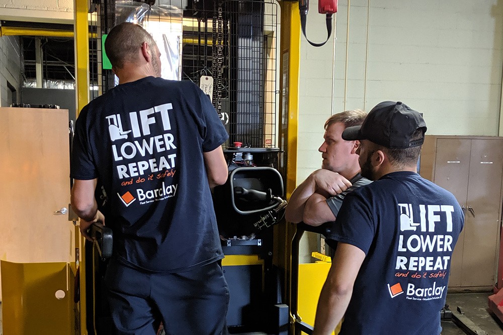 Barclay techs working on a forklift