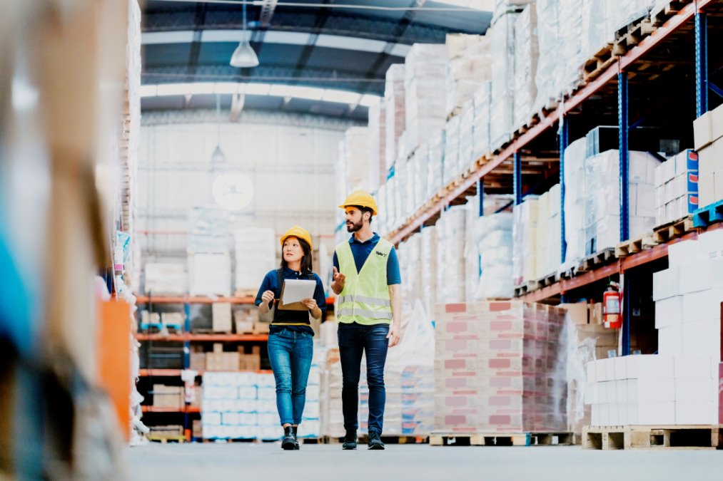 Two workers walking through a warehouse